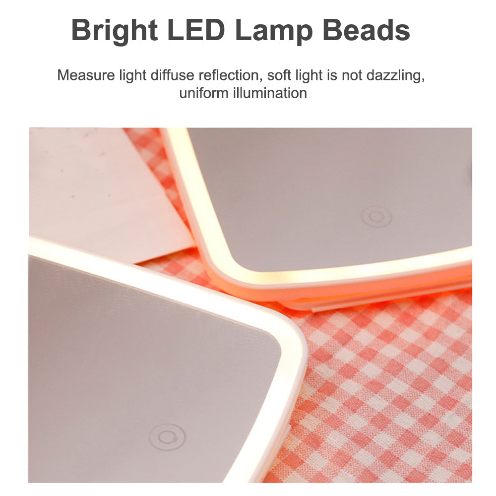 LED Makeup Mirror with touch screen and USB charging, featuring adjustable brightness and angle, available in white and pink.